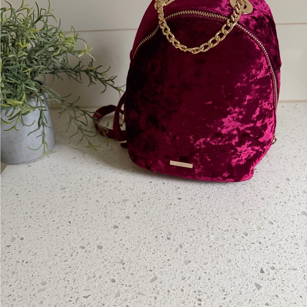 Aldo Velvet Maroon Backpack with Gold Accents